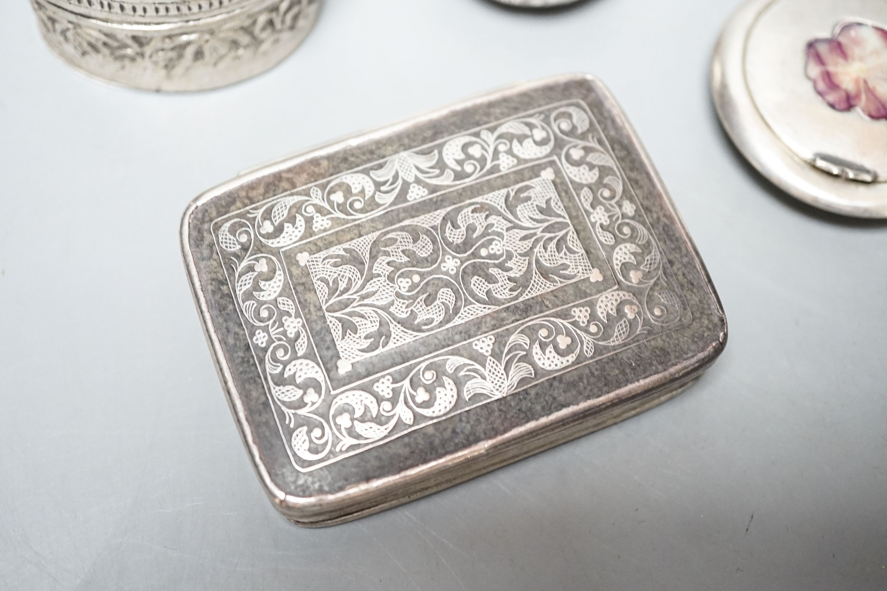A selection of three small silver or white metal boxes to include a tortoiseshell pique box and a silver and shell inlaid compact.